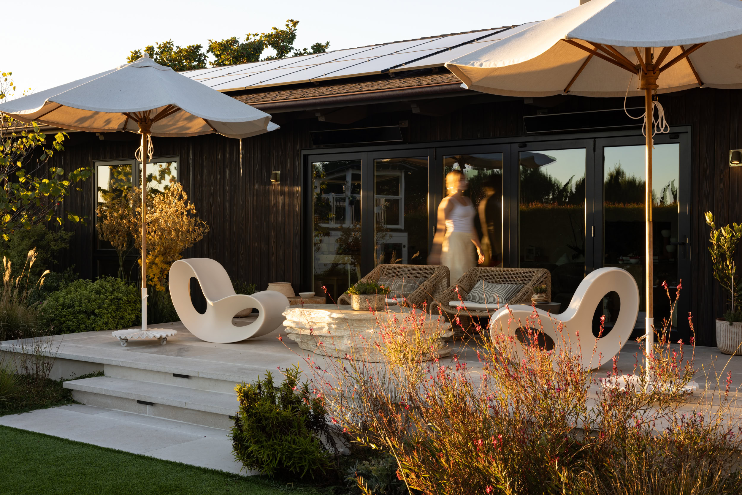 Contemporary outdoor patio furniture with umbrellas at South Harlow Interiors.