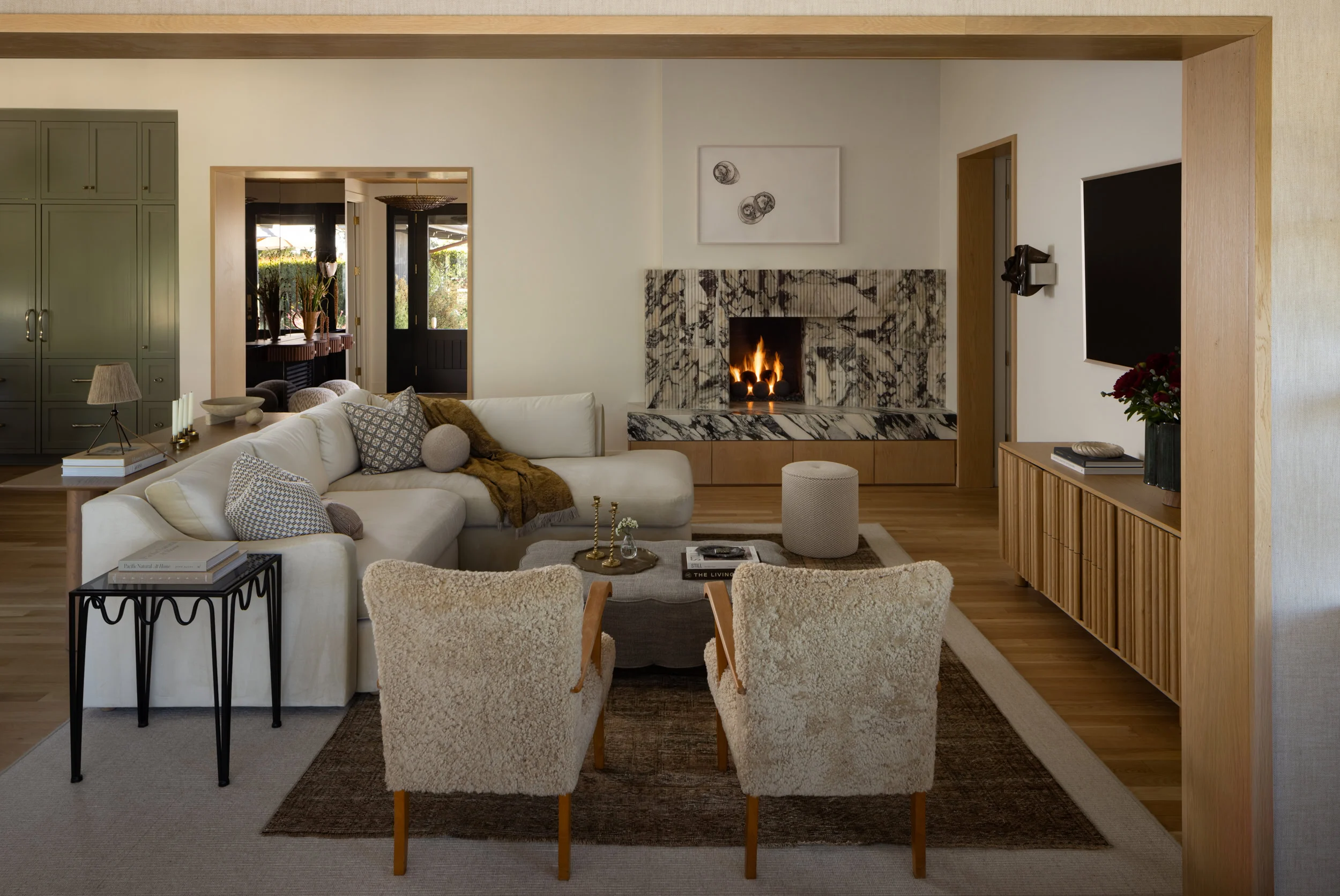 Modern living room with fireplace and cozy seating area.