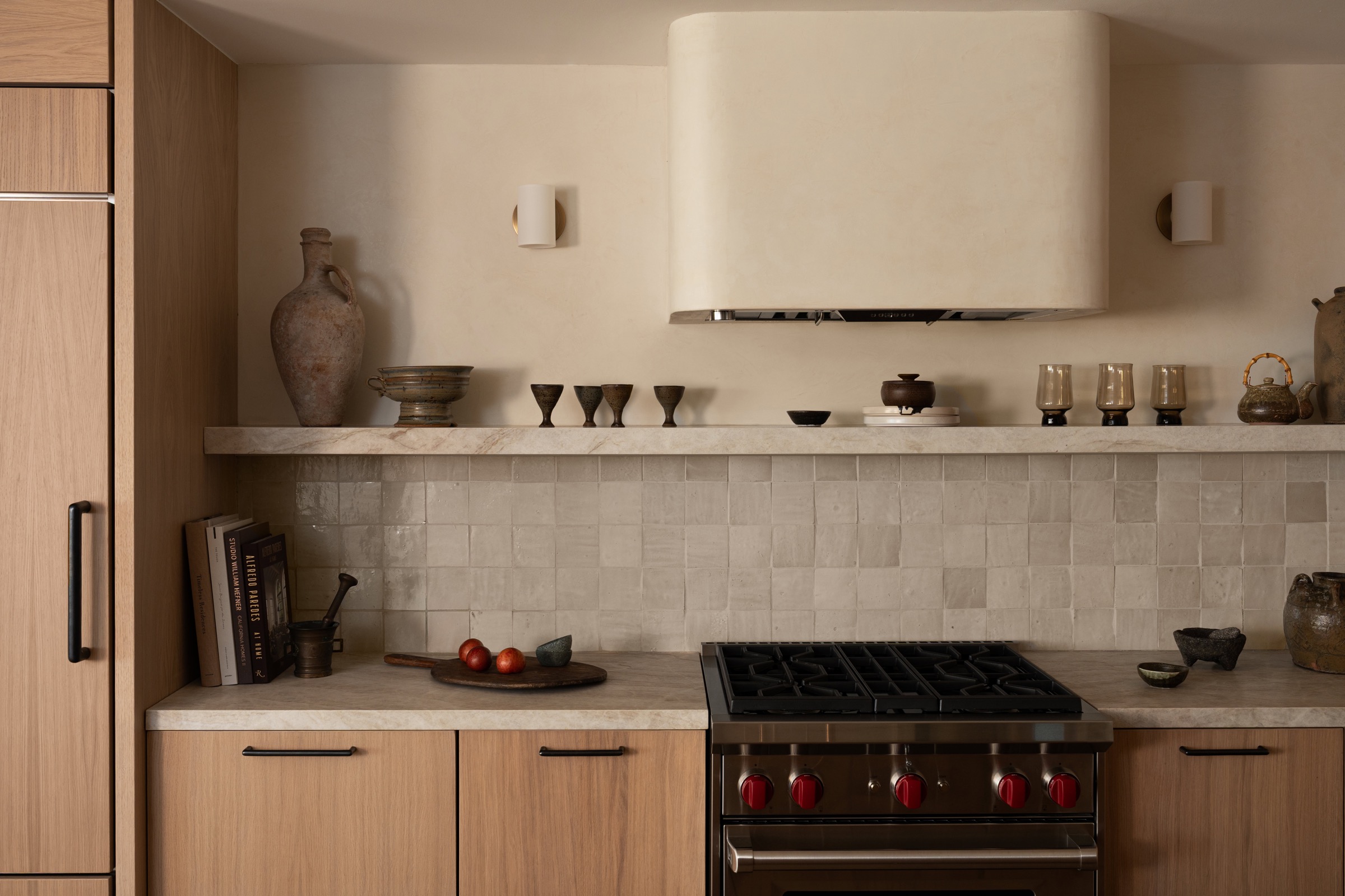 Modern kitchen with wooden cabinets, stove, and decorative items for stylish interiors.