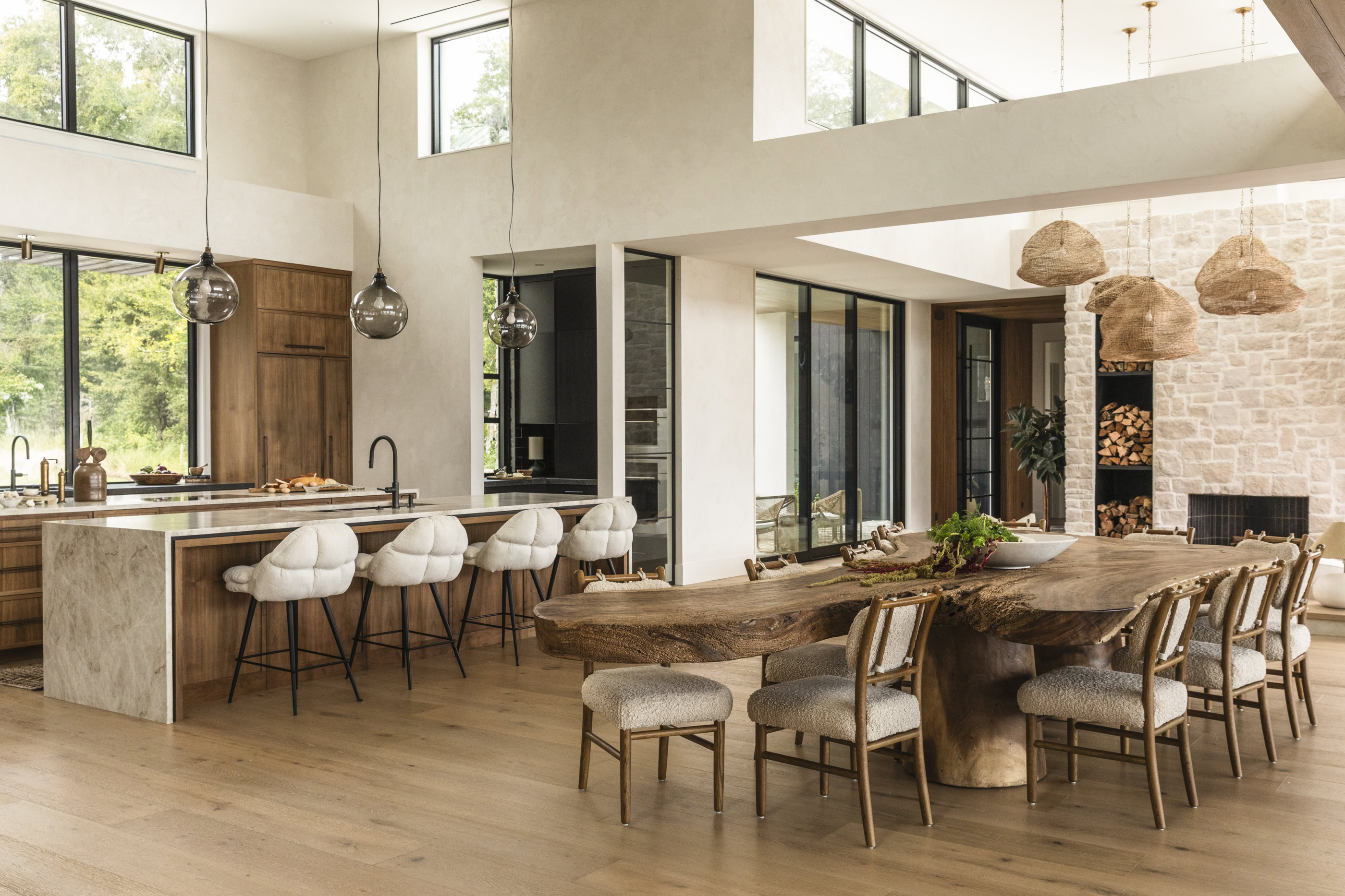Contemporary dining room with wooden furniture and large windows, showcasing natural light and moder.