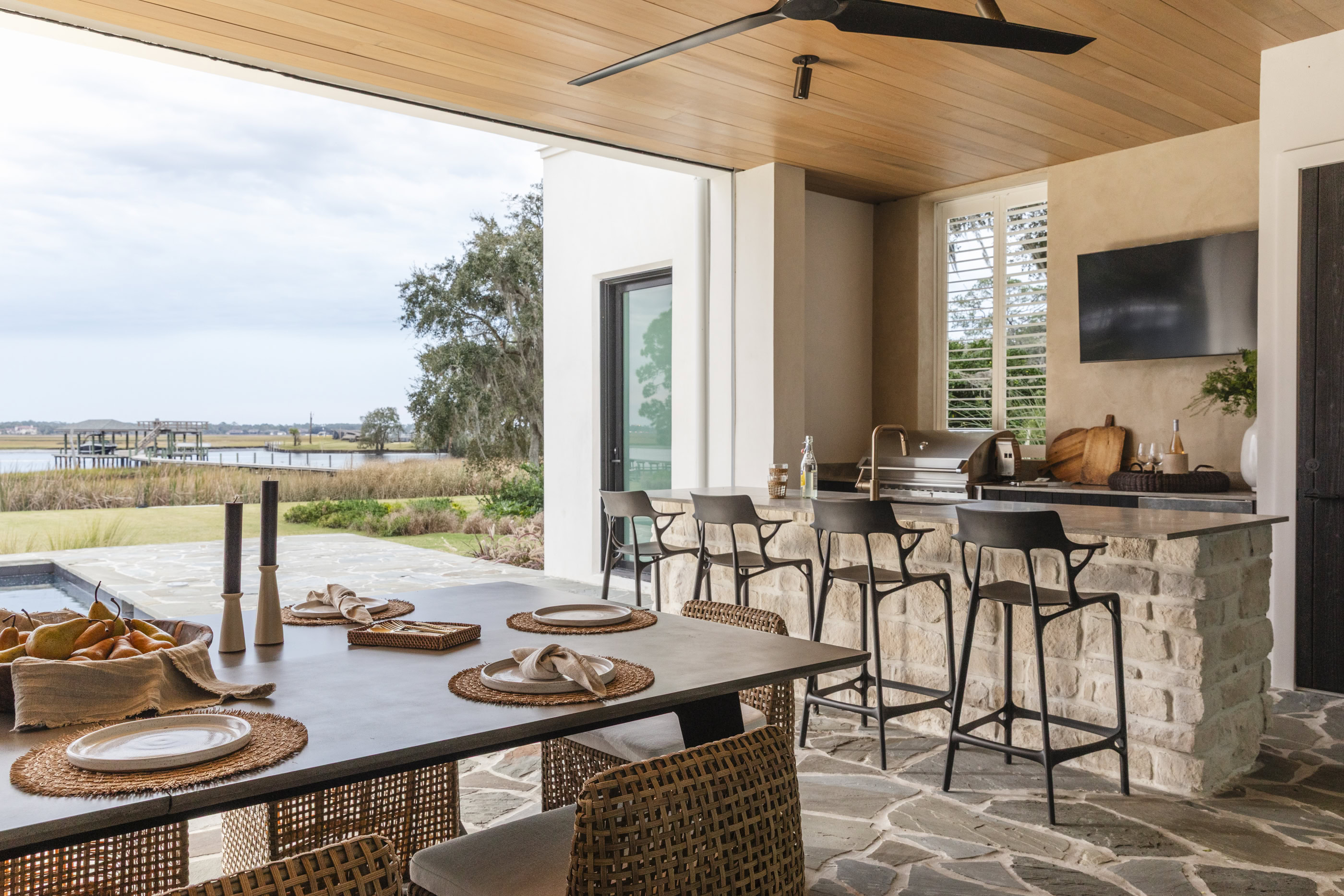 Bright coastal interior with open view, modern furniture, and natural materials.