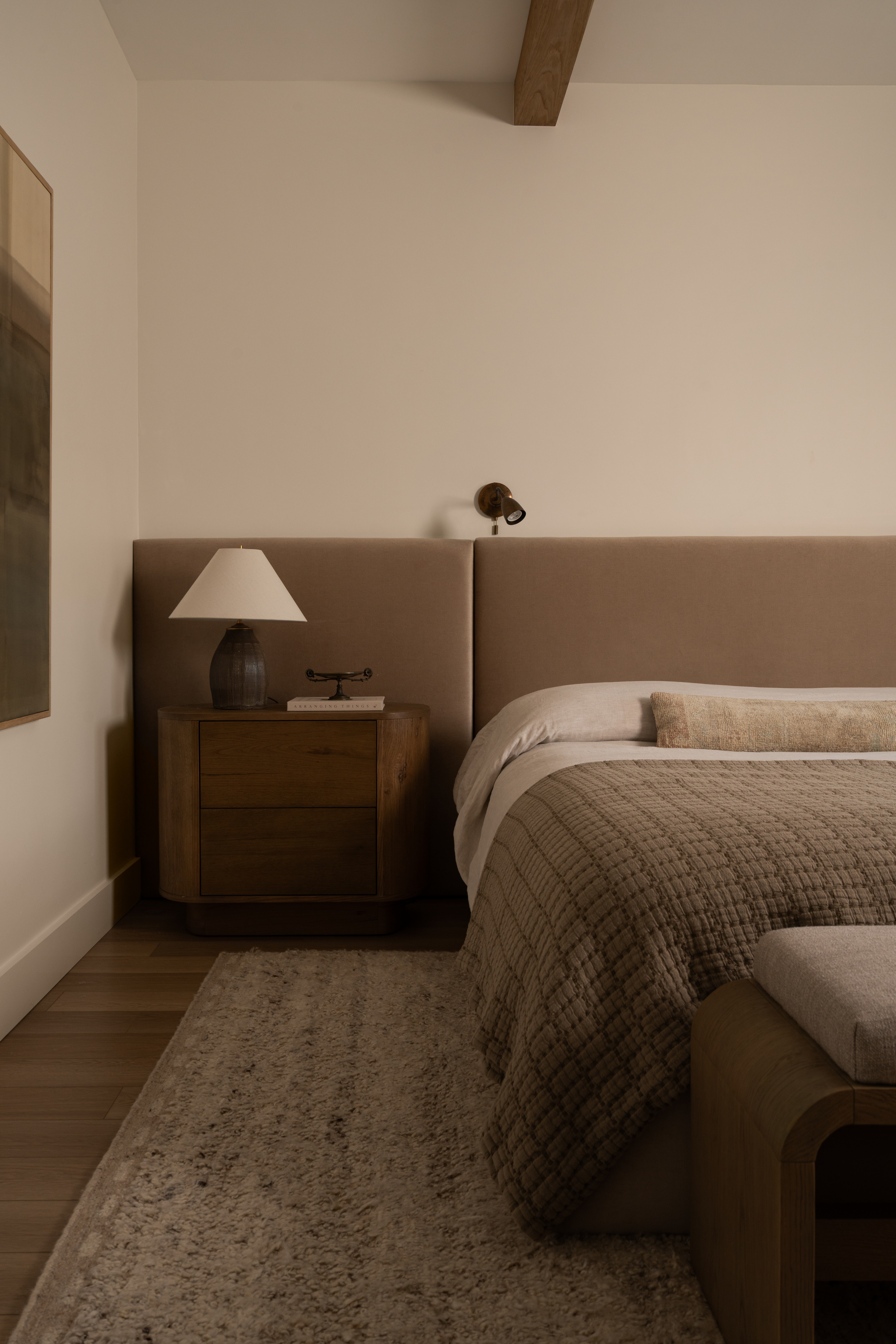 Modern bedroom interior with neutral tones and cozy decor.