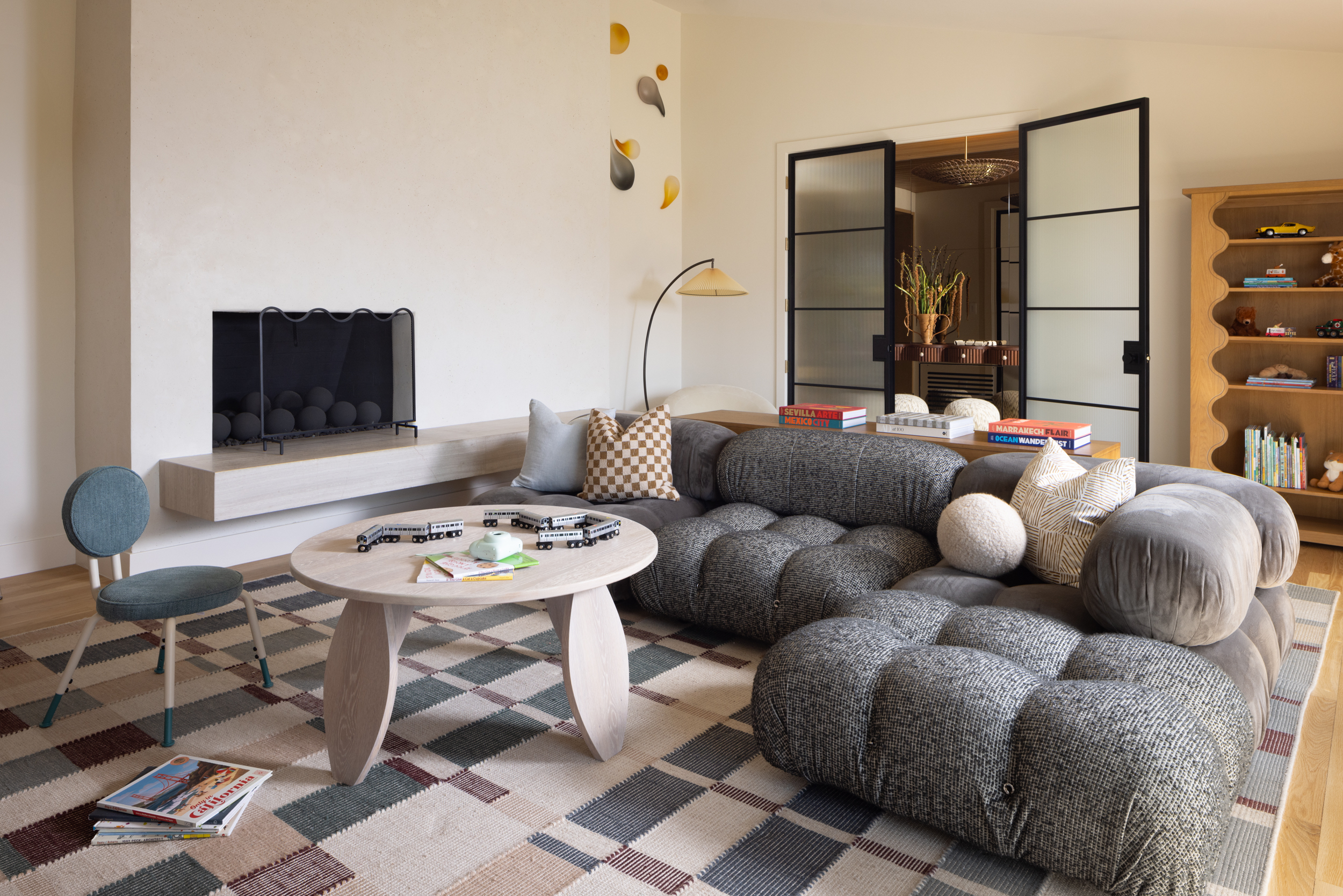 Modern living room with grey sectional sofa and contemporary decor.