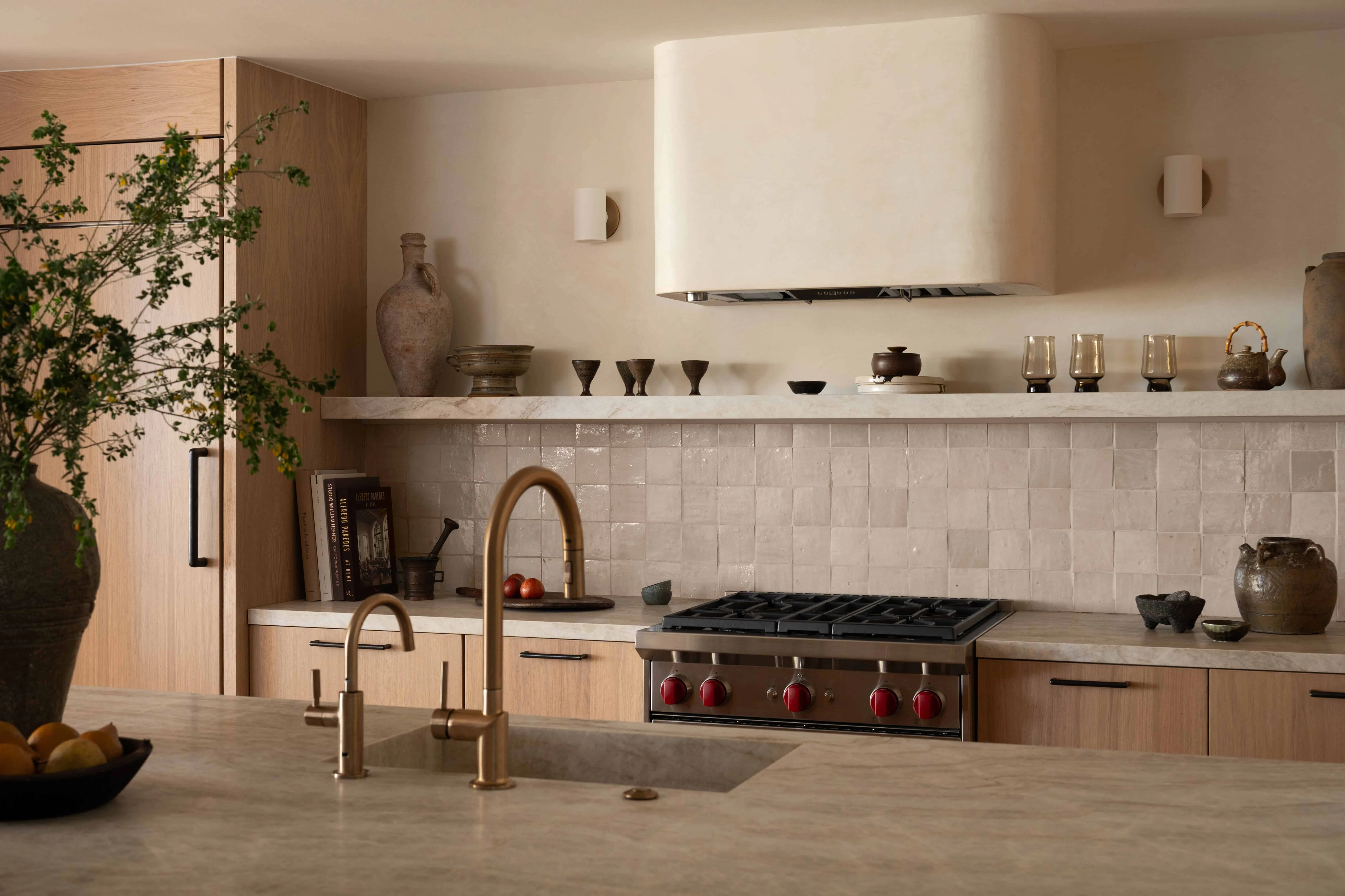 Modern kitchen with beige walls, wooden cabinets, and a marble countertop.