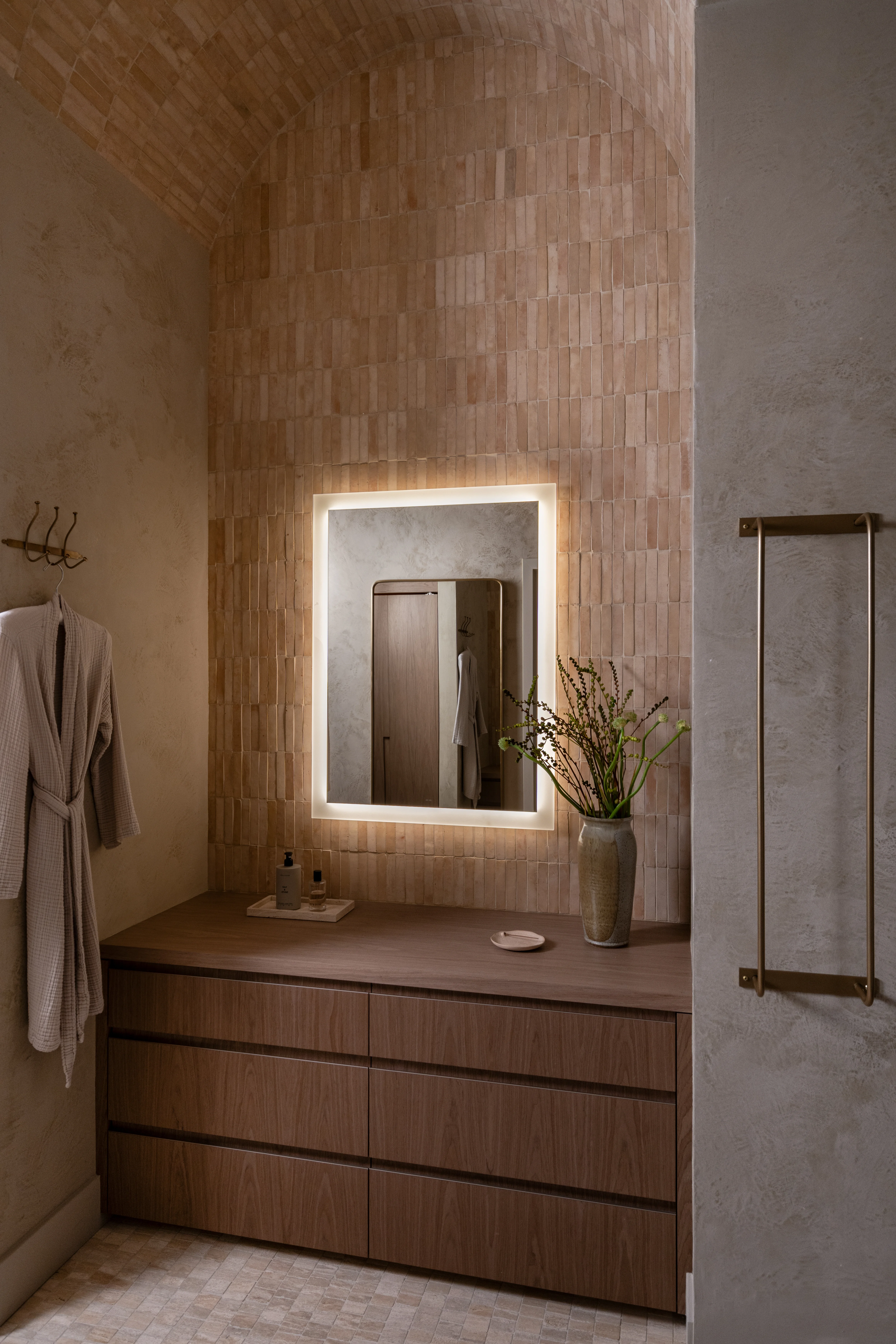 Stone vanity and shower in the IOwn workplace spa.
