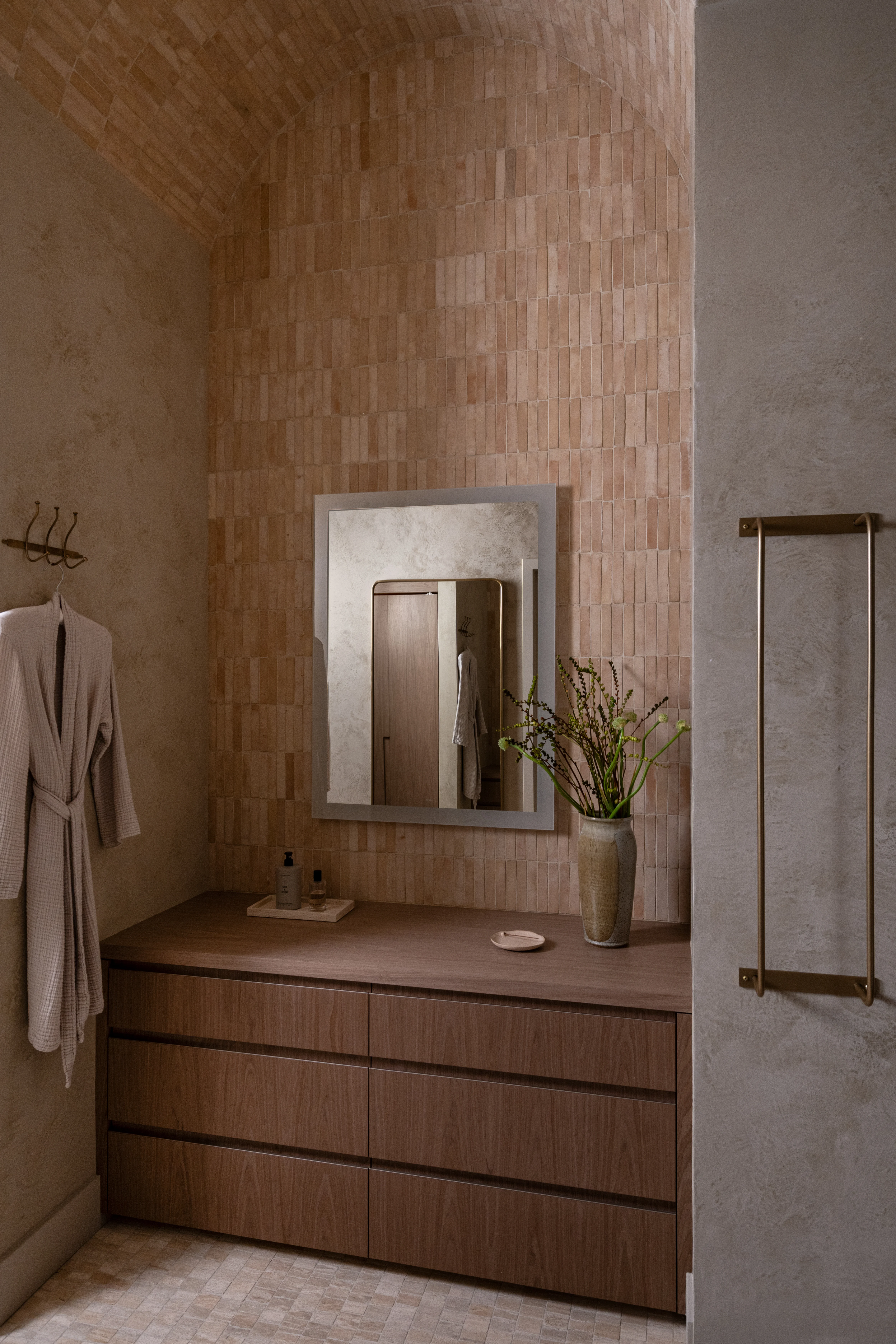 Warm wood vanity and shower in the IOwn workplace spa.