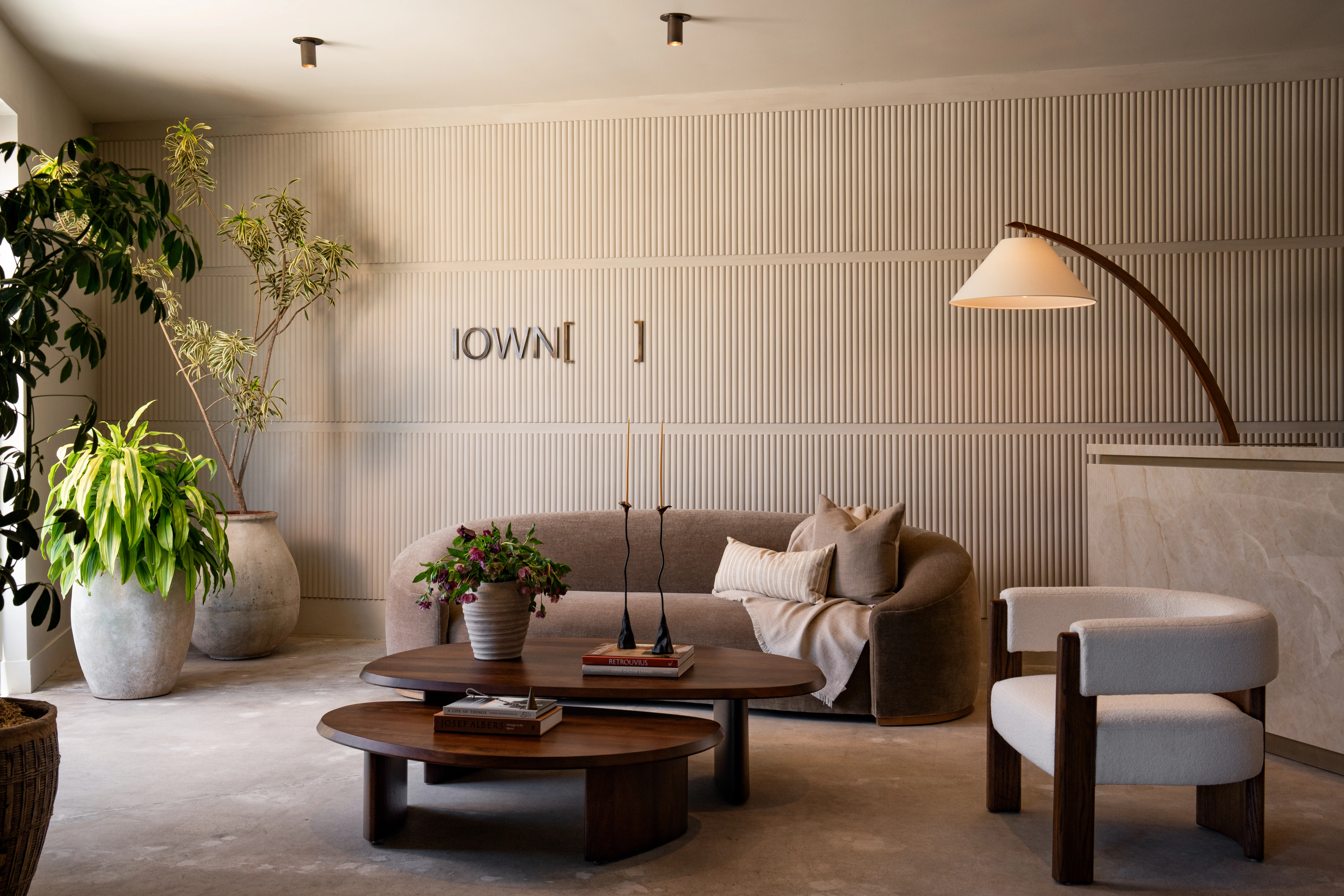 Wide view of the softly layered IOwn reception lounge.