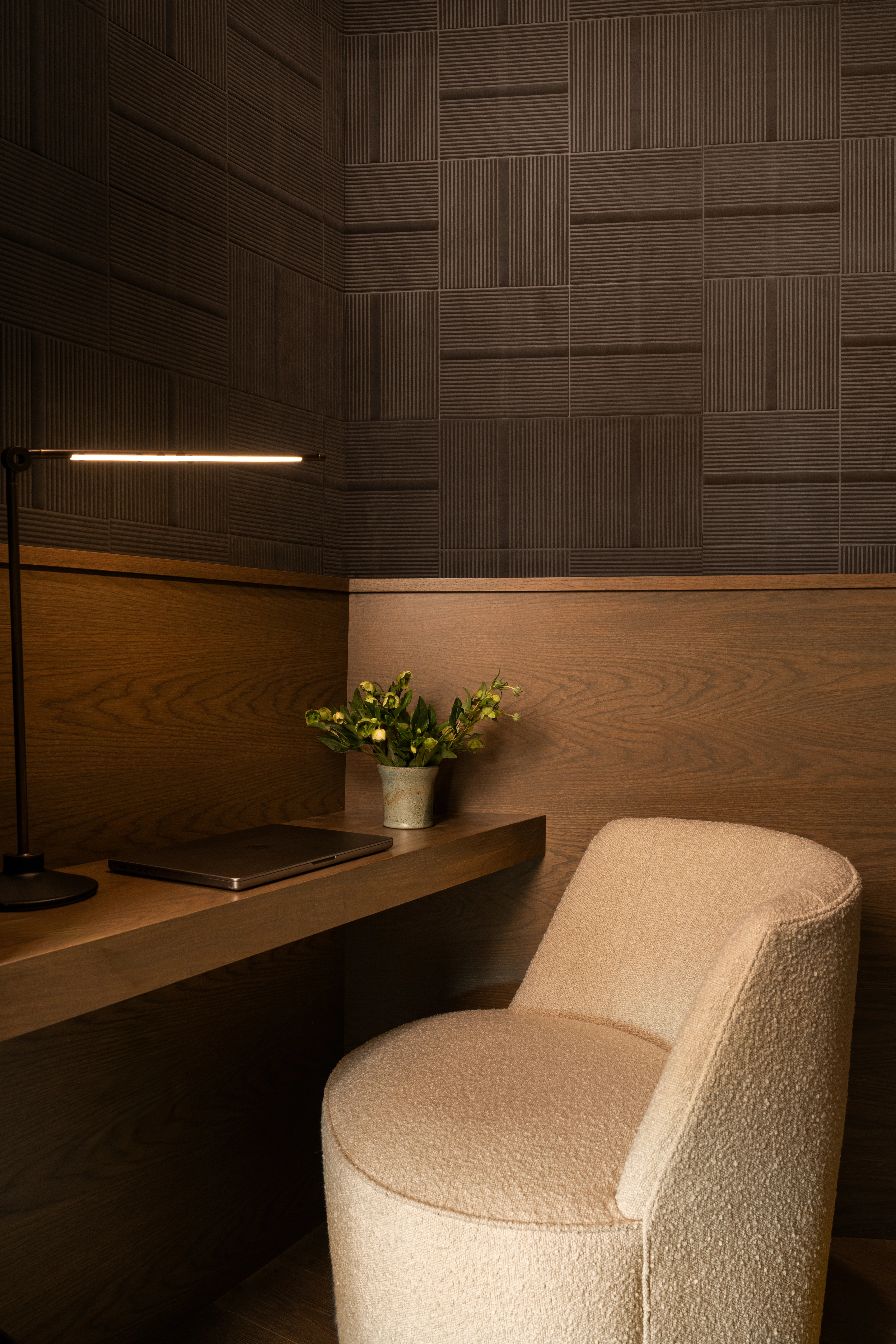 Private meeting booth with layered dark wood walls.