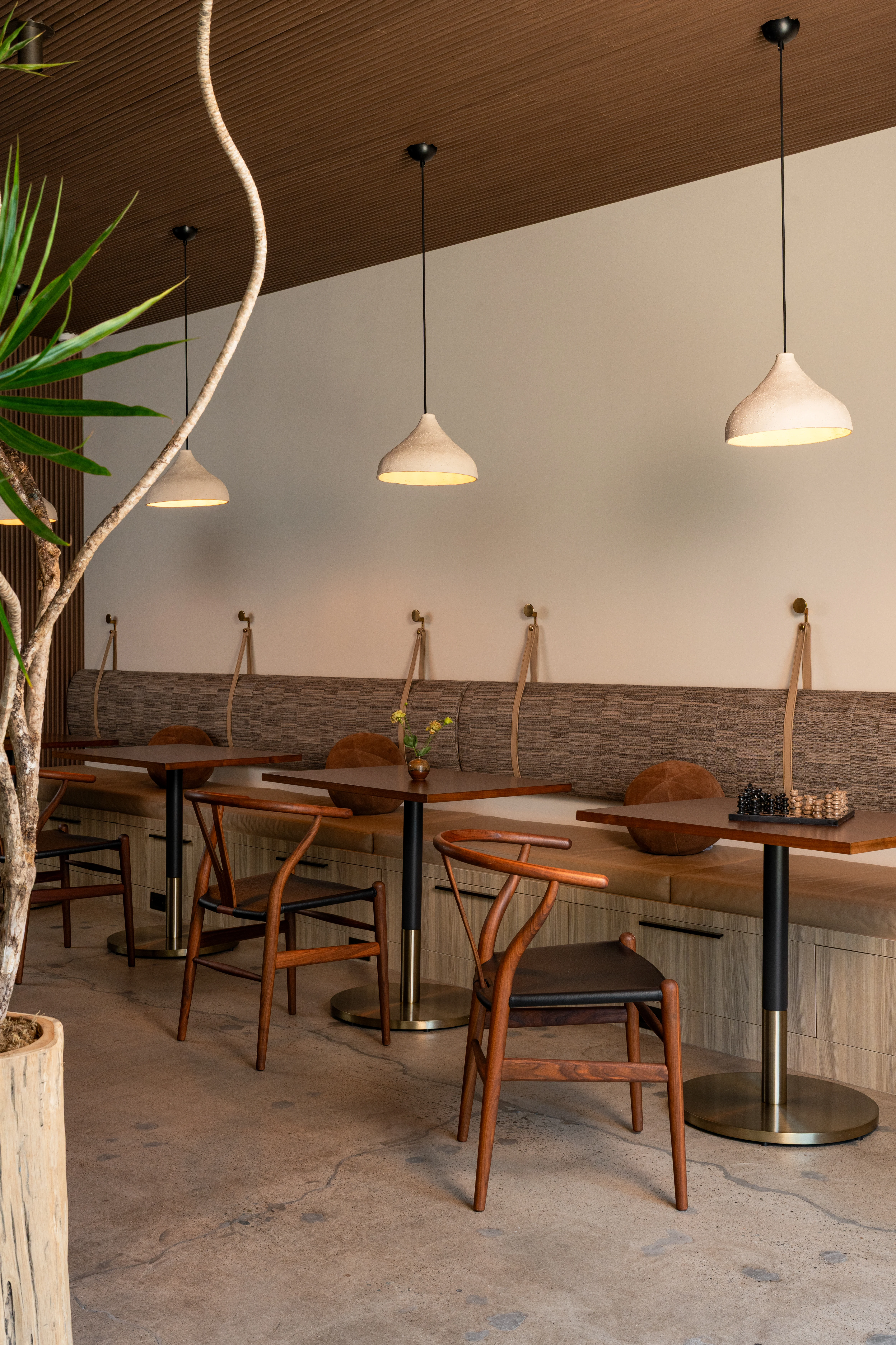 Communal workspace with wood ceiling and pendant lights.